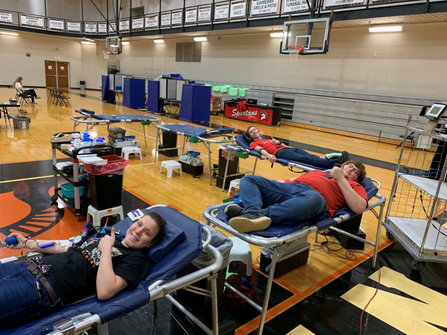 people laying on blood donation cots